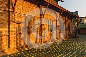 Red bricks wall under the sunlight with shadow on it