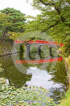 Red bridge in the grounds of Hirosaki Castle, Aomori, Japan.