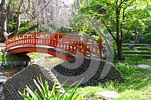 Red bridge in a japanese garden in summer , Paris.