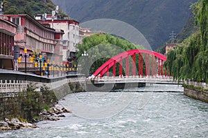 The red bridge of Kangding city in local market.