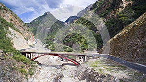 Red bridge with mountain behind