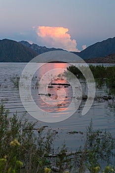 Red bright sunset in the mountain lake