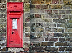 A red British post box in a wall with the royal cypher VR photo