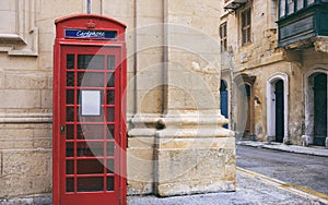 Red British vintage telephone booth in Valletta, Malta