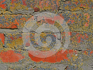 red broken brick wall with gray cement close up grunge