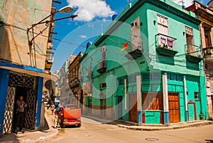 Red broken car. Street scene with classic old cars and traditional colorful buildings in downtown Havana. Cuba