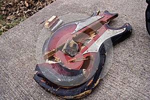 Red Broken Guitar on Concrete