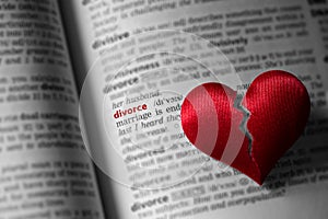 Red broken heart on dictionary divorce definition. The concept of divorce, parting, infidelity . Selective focus