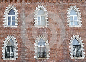 Red brown brick block Castle wall with window in old city in Europe on the snow day