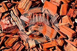 Red, brown and orange wood chip mulch with split wood texture