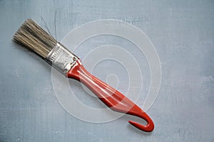 Red brush isolated on a blue background, top view. photo