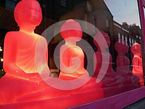 Red buddhas in shop window