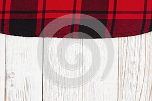 Red buffalo plaid border material holiday background on weathered wood