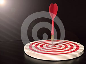 Red bullseye dart arrow hitting target center of dartboard. Concept of success, target, goal, achievement