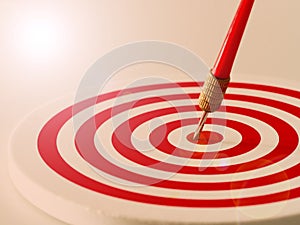 Red bullseye dart arrow hitting target center of dartboard. Concept of success, target, goal, achievement. Vintage with flare tone