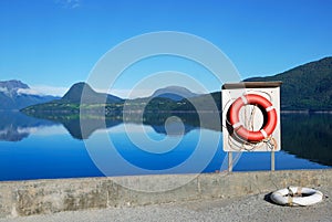 Red buoy against the blue view of fjord
