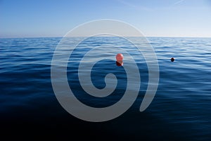 Red buoy on blue sea