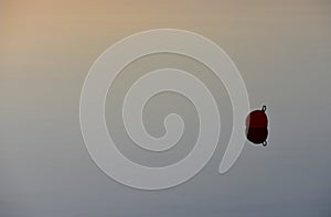 Red buoy in calm water