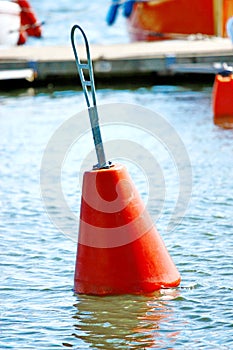 A red buoy floating on boat parking