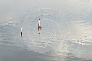 Red buoy floating on calm water