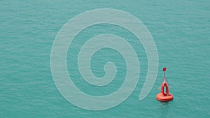 Red buoy floating in sea water