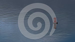 Red buoy floating on still water drone shot. Safe boats traveling concept.