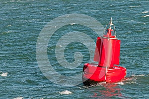 A red buoy floating on water