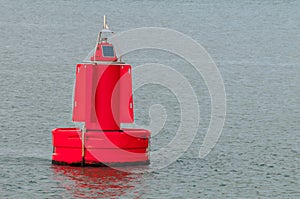 A red buoy floating on water