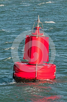 A red buoy floating on water