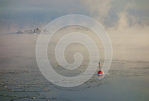 Red buoy in the freezing Baltic Sea in Helsinki, Finland