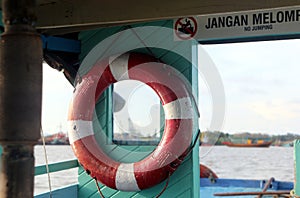 Red buoy hanging in wooden boat