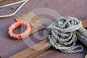 Red buoy life safety ring on pontoon and safety rope