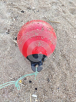 the red buoy is lying on the shore with the rope torn off. Ayia Napa. Cyprus.
