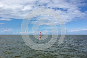 A Red Buoy on the North Sea in the East Frisian Wadden Sea in front of Juist Island, Germany