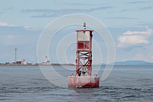 Red buoy with Point Wilson Lighthouse backdrop