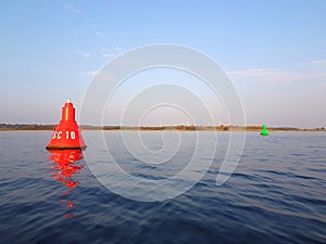 A red buoy on the river for the safety