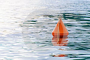 Red buoy on the sea waves