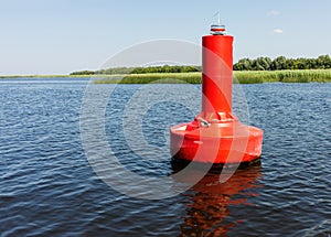 Red buoy on the water of the lagoon