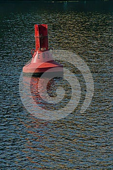 Red buoy in the water of a river