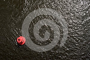 Red buoy on the water surface