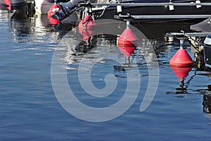 Red buoys in calm water of a marina