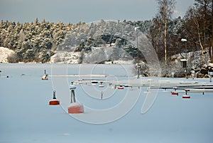 Red buoys in frozen water in winter