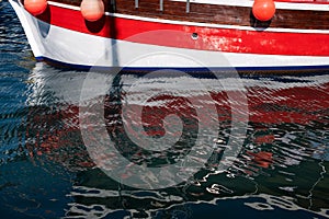 Red buoys hanging on side of boat in Porec, Croatia