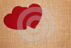 Red Burlap Love Hearts on a Brown Burlap Background