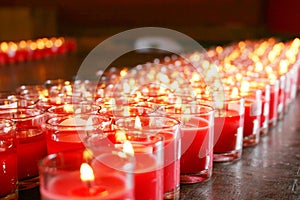 Red burning candle in a temple