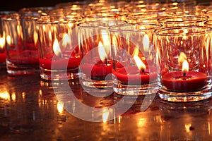 Red burning candle in a temple