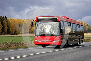 Red Bus on Highway in Autumn