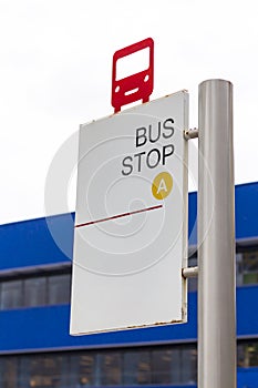 Red bus shape on bus stop sign