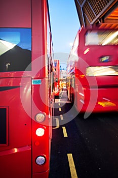 Red bus traffic by night in London