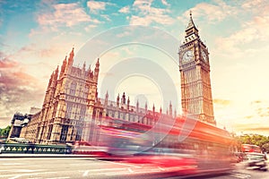 Red bus on Westminster bridge next to Big Ben in London, the UK.